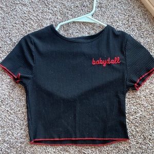 Size small. BabyDoll embroidery with red lining on the bottom and arms